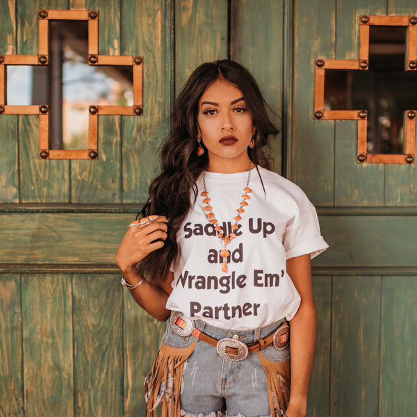 “Saddle Up And Wrangle Em’ Partner” Tee